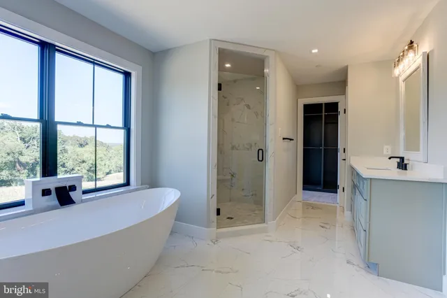 a large spacious bathroom with a large tub shower and sink