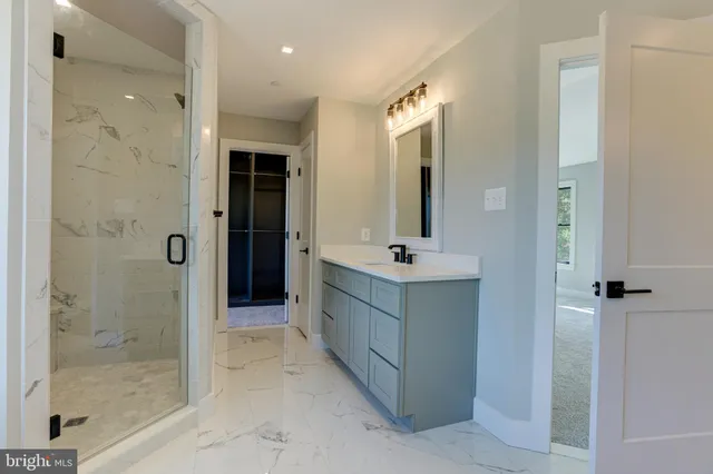 a bathroom with a double vanity sink mirror and shower