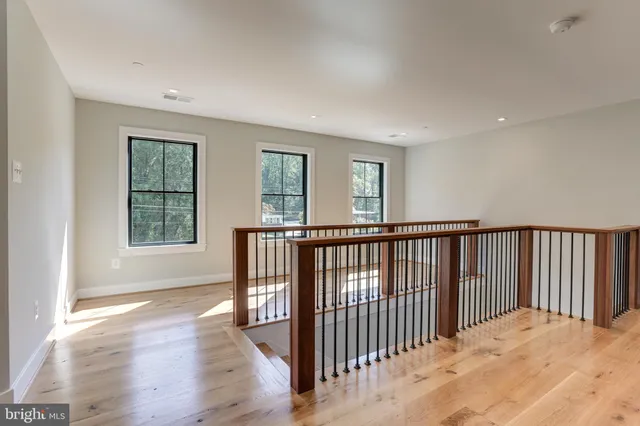 a view of a room with wooden floor