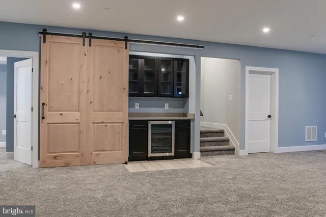 an empty room with a fireplace and entryway
