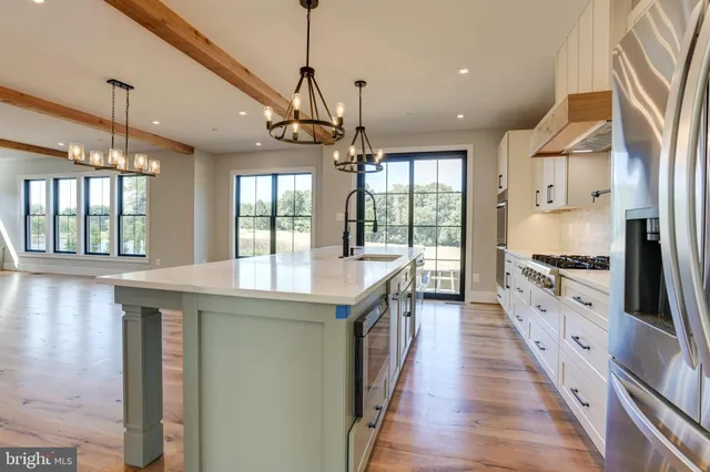 a kitchen with stainless steel appliances granite countertop a stove and refrigerator