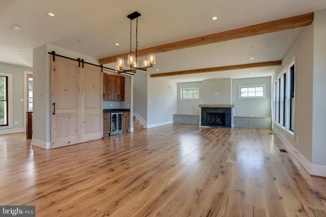 a view of empty room with wooden floor and fireplace
