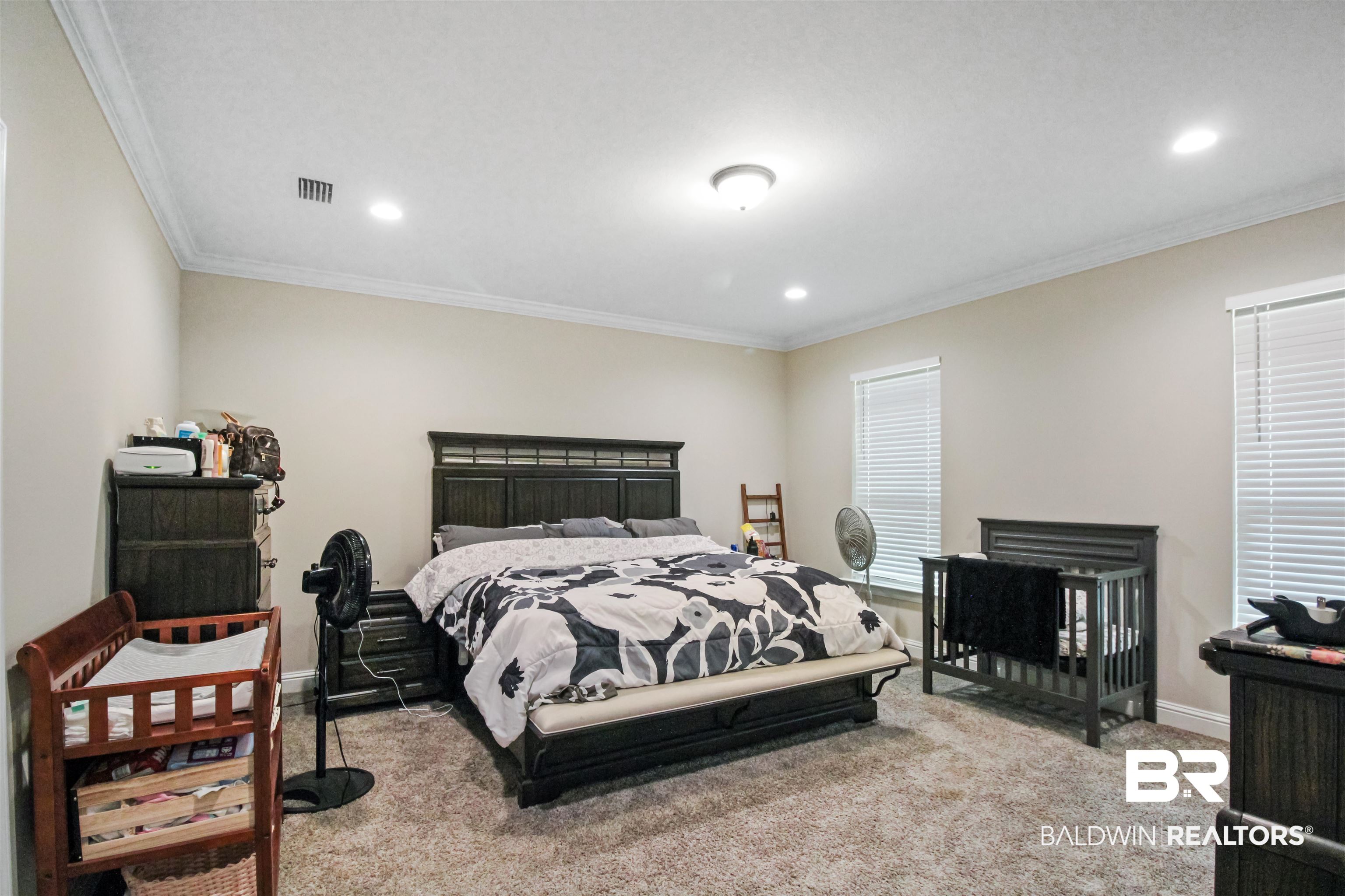 26197 Eagle Trace Elberta, AL 36530 - Photo 16 of 26 Bedroom featuring ornamental molding and light colored carpet