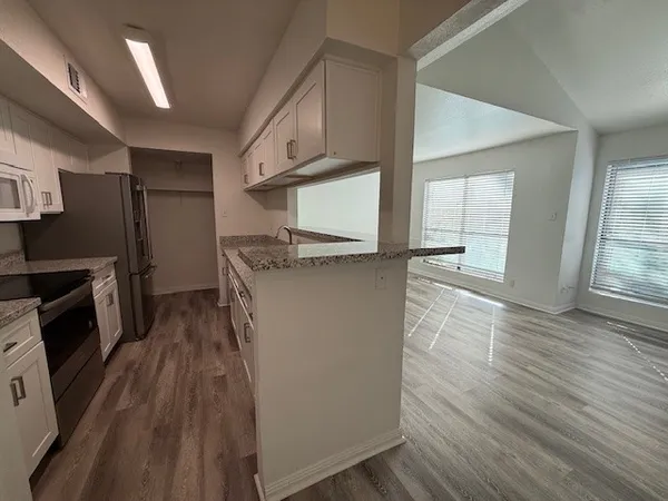 a kitchen with stainless steel appliances a refrigerator and a stove
