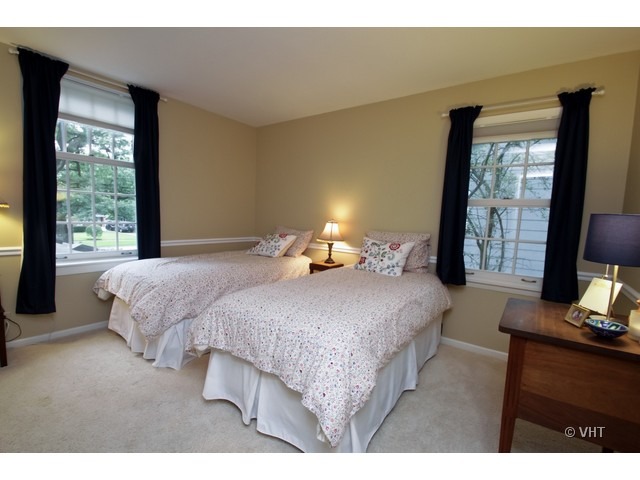 1460 Edgewood Road Lake Forest, IL 60045 - Photo 17 of 21 a bedroom with a bed and large windows