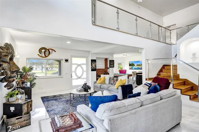 a kitchen with a table chairs cabinets and stainless steel appliances