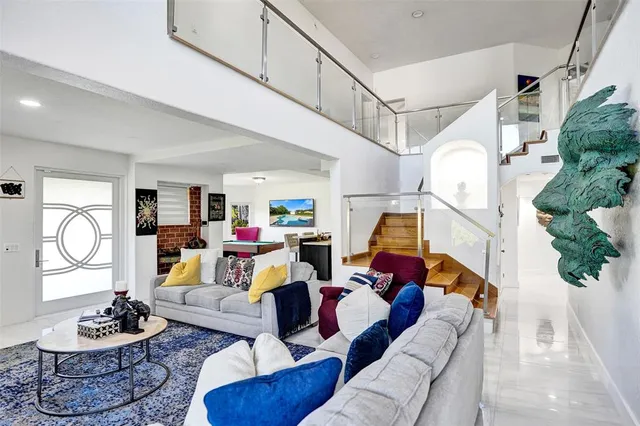 a kitchen with stainless steel appliances granite countertop a sink a stove and a refrigerator