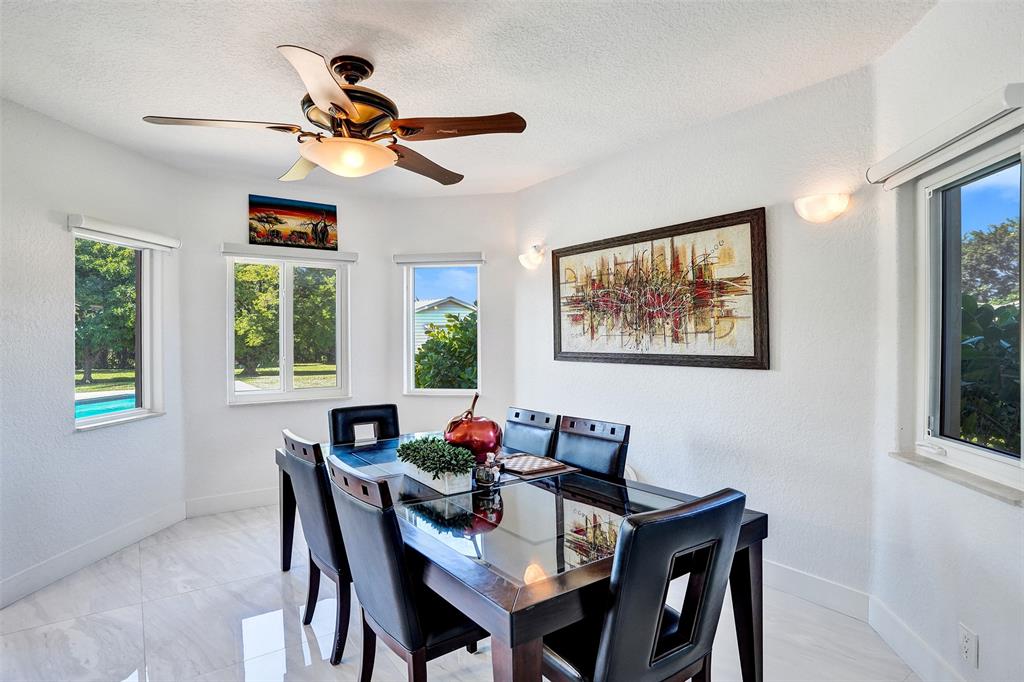 3061 Southwest 117th Avenue Davie, FL 33330 - Photo 14 of 83 a dining room with furniture a window and a chandelier