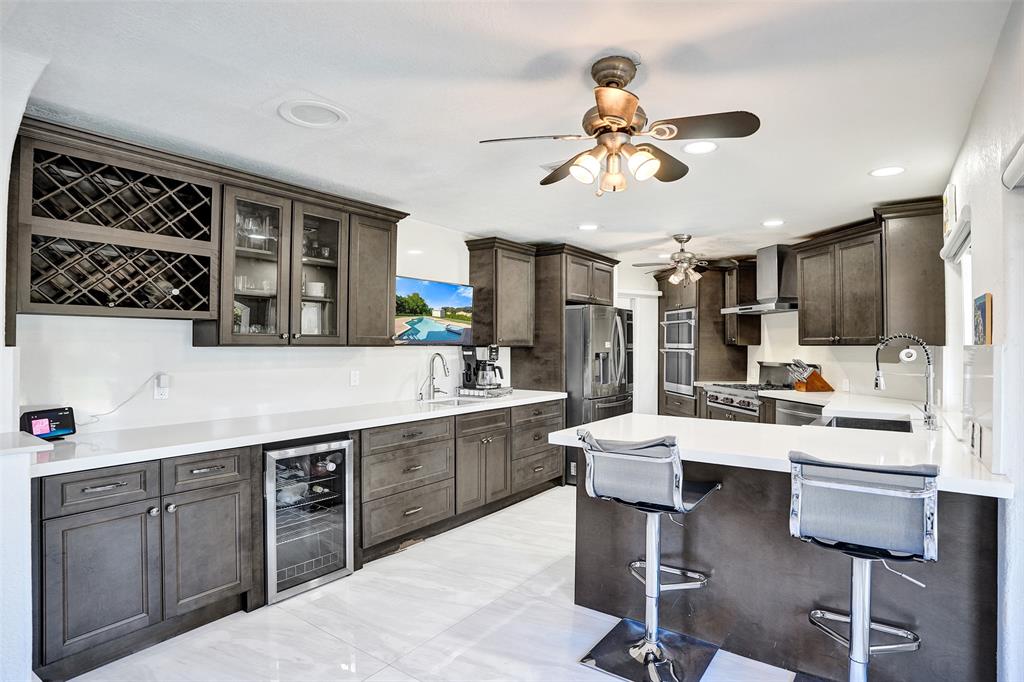 3061 Southwest 117th Avenue Davie, FL 33330 - Photo 16 of 83 a kitchen with a table chairs cabinets and stainless steel appliances