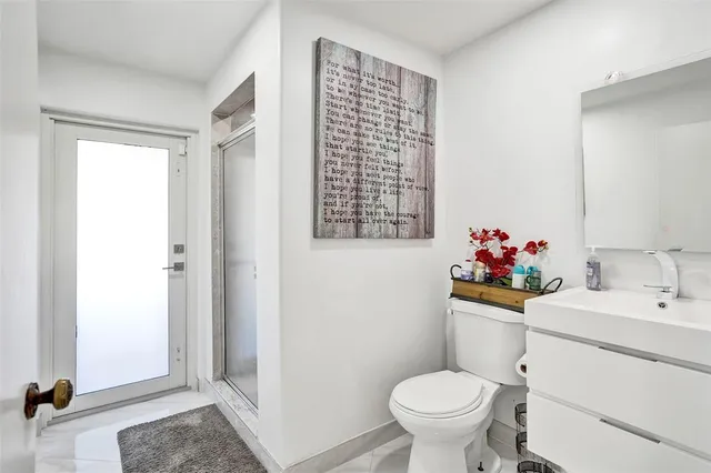 a spacious bathroom with a double vanity sink a mirror and shower