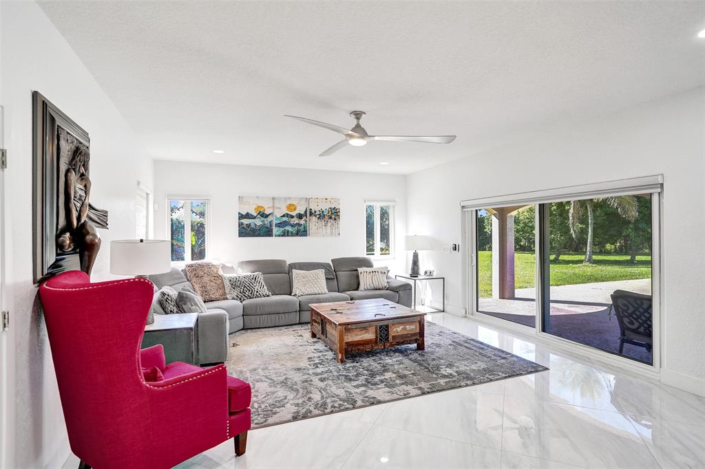3061 Southwest 117th Avenue Davie, FL 33330 - Photo 22 of 83 a living room with furniture and a large window with balcony view