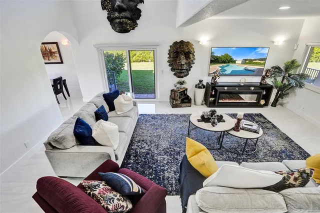 a view of a porch with furniture and floor to ceiling window
