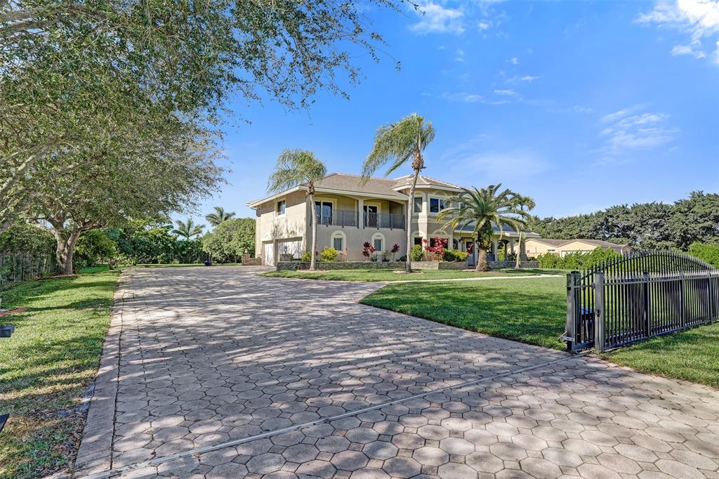 3061 Southwest 117th Avenue Davie, FL 33330 - Photo 3 of 83 a front view of a house with a yard and potted plants