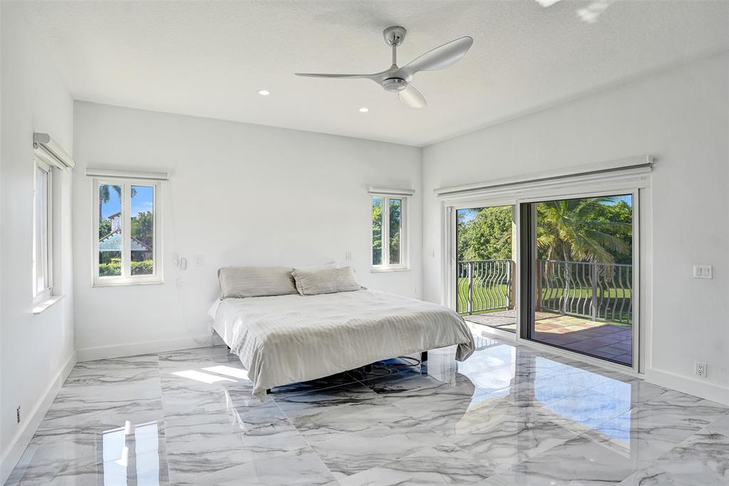 3061 Southwest 117th Avenue Davie, FL 33330 - Photo 38 of 83 a spacious bedroom with a large bed and a large window