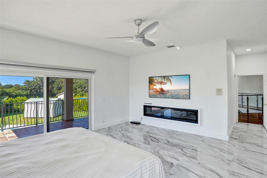 3061 Southwest 117th Avenue Davie, FL 33330 - Photo 39 of 83 a bedroom with a bed and a flat screen tv