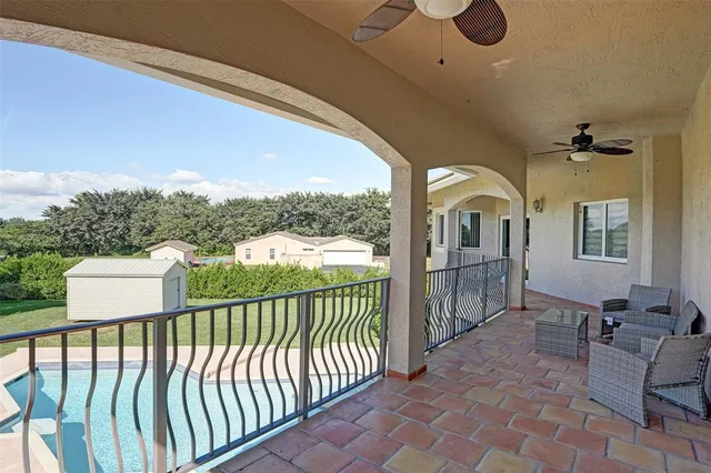 a front view of a house with swimming pool having outdoor seating