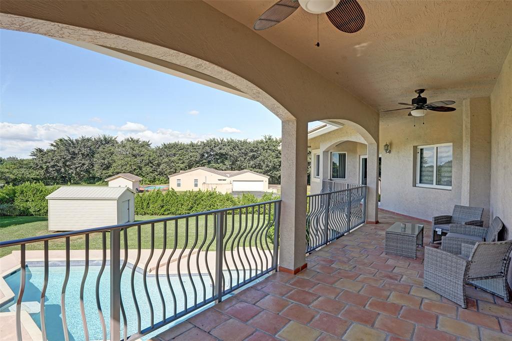 3061 Southwest 117th Avenue Davie, FL 33330 - Photo 40 of 83 a view of a porch with furniture and floor to ceiling window