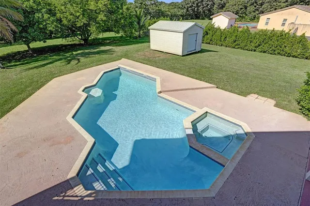 an aerial view of a house with garden space and street view