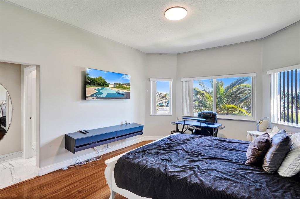 3061 Southwest 117th Avenue Davie, FL 33330 - Photo 44 of 83 a bed room with a bed and a chair