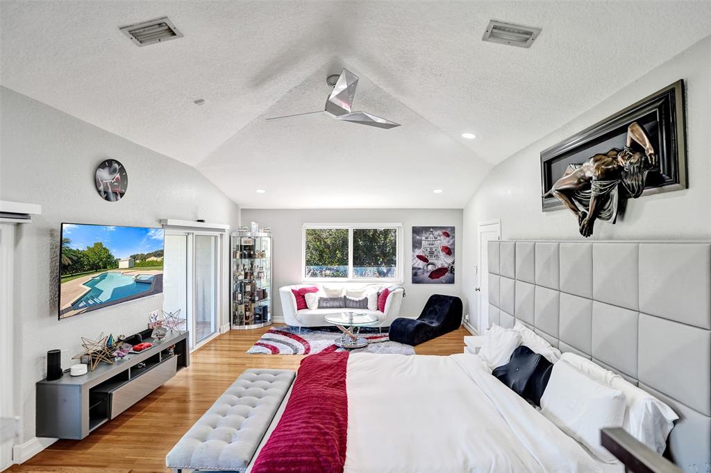3061 Southwest 117th Avenue Davie, FL 33330 - Photo 46 of 83 a bedroom with a bed and a flat tv screen on the dresser