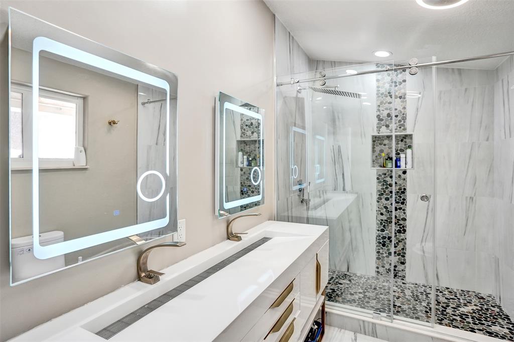 3061 Southwest 117th Avenue Davie, FL 33330 - Photo 48 of 83 a bathroom with a granite countertop sink a mirror a vanity and a shower