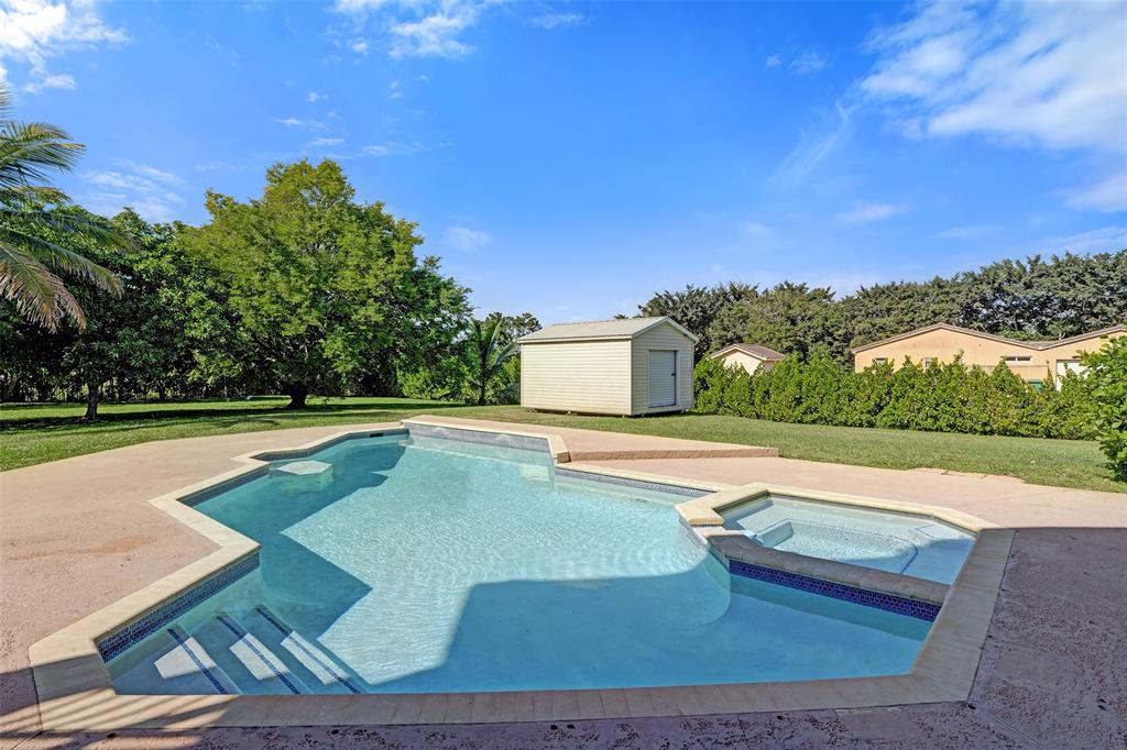 3061 Southwest 117th Avenue Davie, FL 33330 - Photo 60 of 83 a view of a swimming pool with an outdoor space and seating area