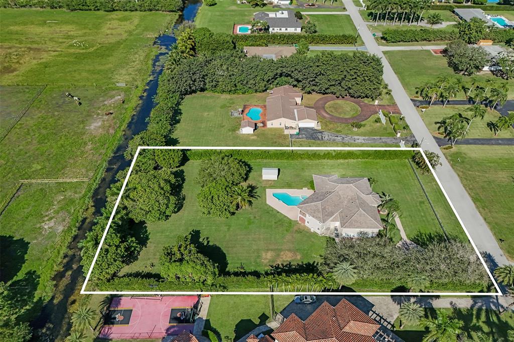 3061 Southwest 117th Avenue Davie, FL 33330 - Photo 75 of 83 an aerial view of a houses with a yard