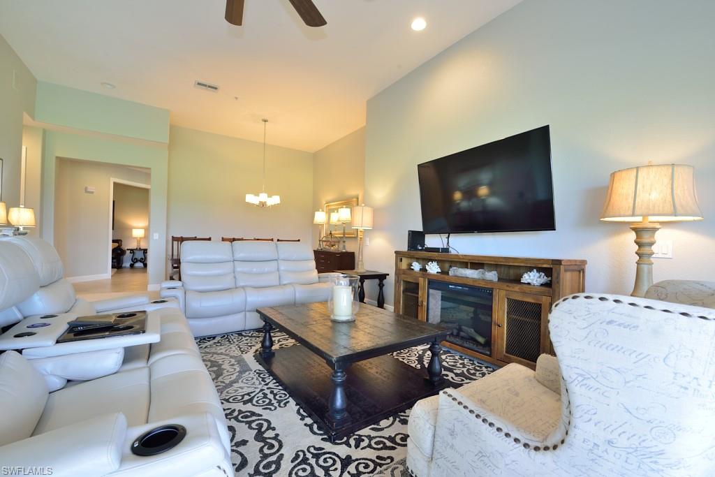 3960 Deer Crossing Court, Unit 6204 Naples, FL 34114 - Photo 13 of 23 a living room with furniture and a flat screen tv