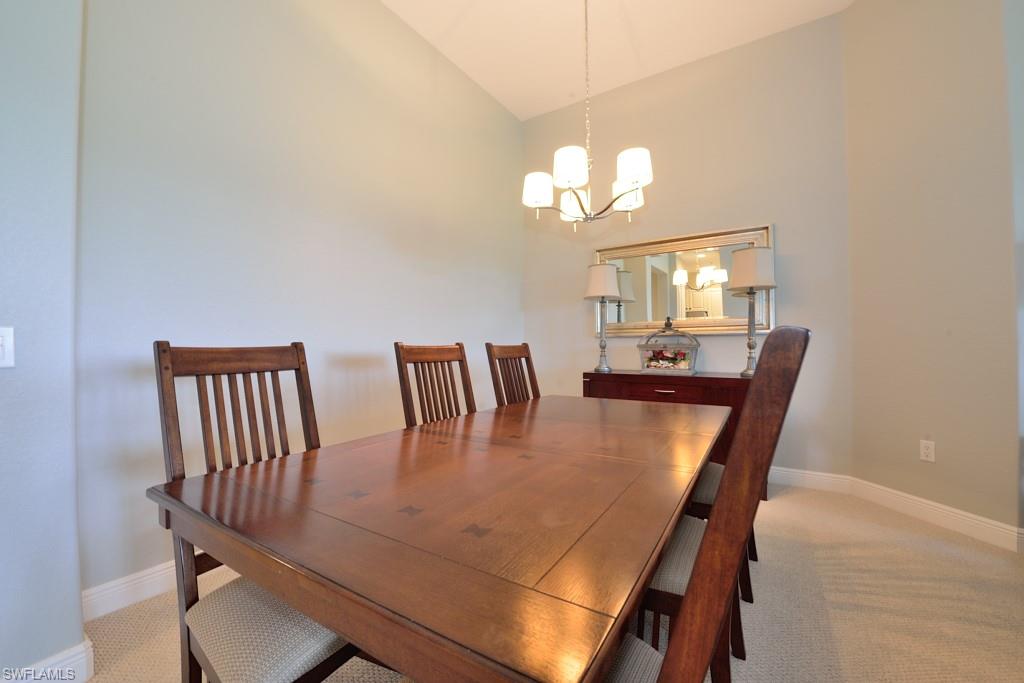3960 Deer Crossing Court, Unit 6204 Naples, FL 34114 - Photo 14 of 23 a view of a dining room with furniture