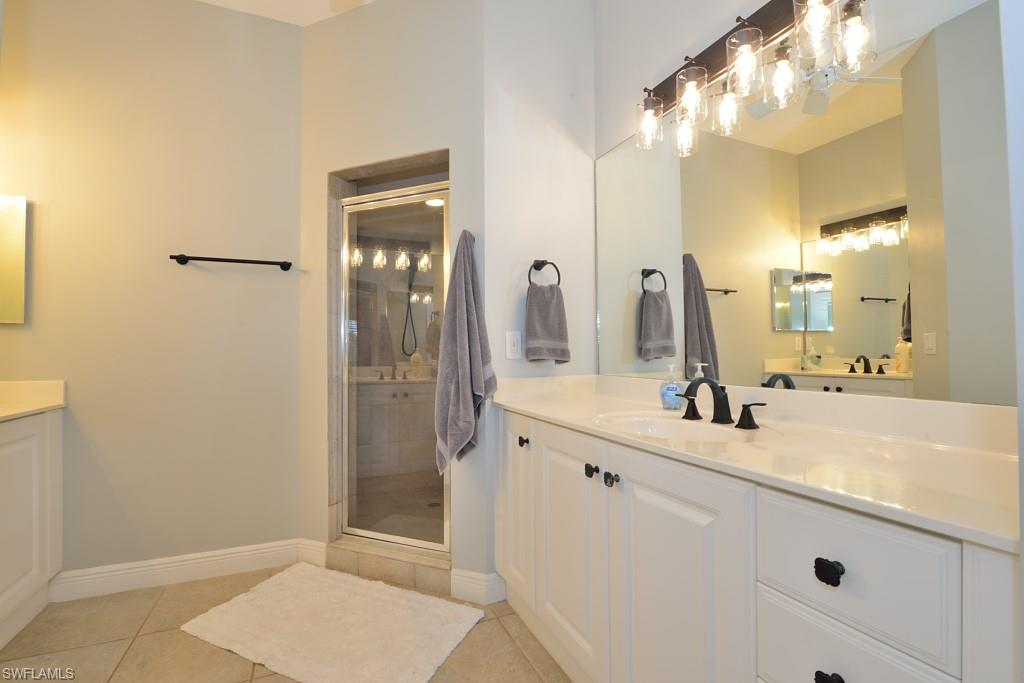 3960 Deer Crossing Court, Unit 6204 Naples, FL 34114 - Photo 16 of 23 a bathroom with a sink and a mirror