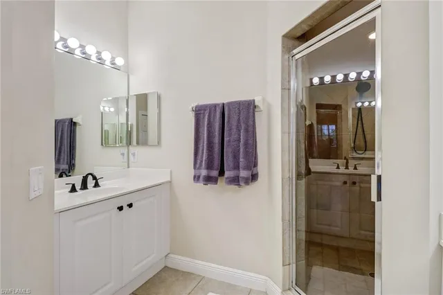 a bathroom with a sink vanity and mirror