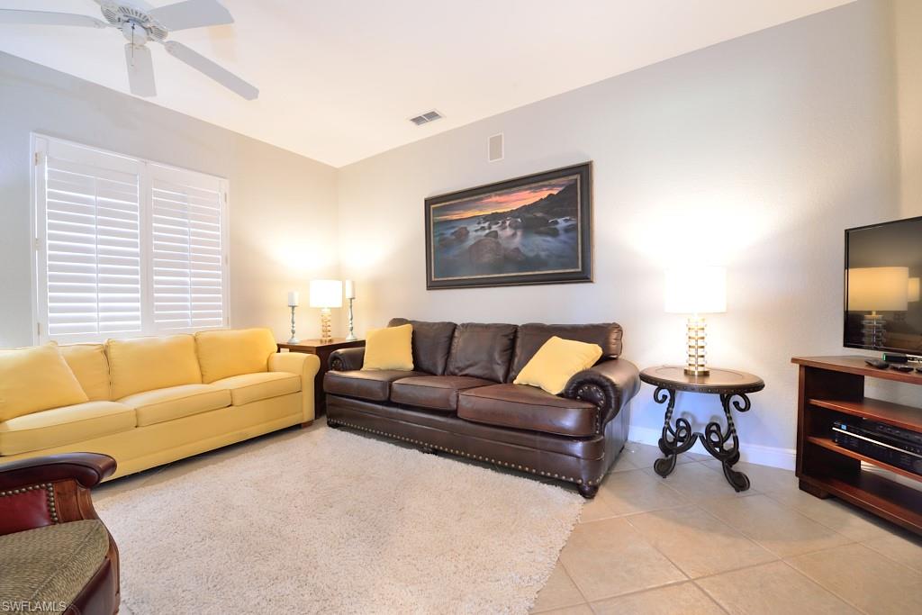3960 Deer Crossing Court, Unit 6204 Naples, FL 34114 - Photo 18 of 23 a living room with furniture a couch and a flat screen tv