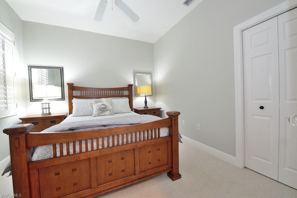 3960 Deer Crossing Court, Unit 6204 Naples, FL 34114 - Photo 19 of 23 a bedroom with a bed and a dresser