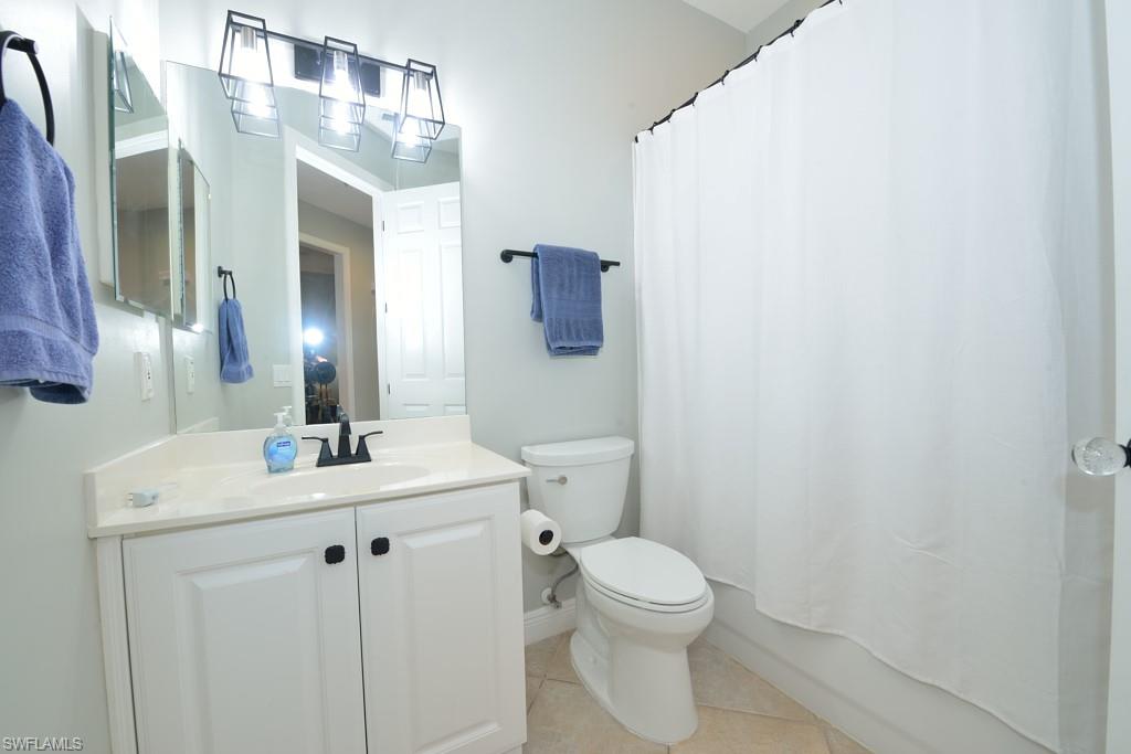 3960 Deer Crossing Court, Unit 6204 Naples, FL 34114 - Photo 20 of 23 a bathroom with a toilet sink and mirror