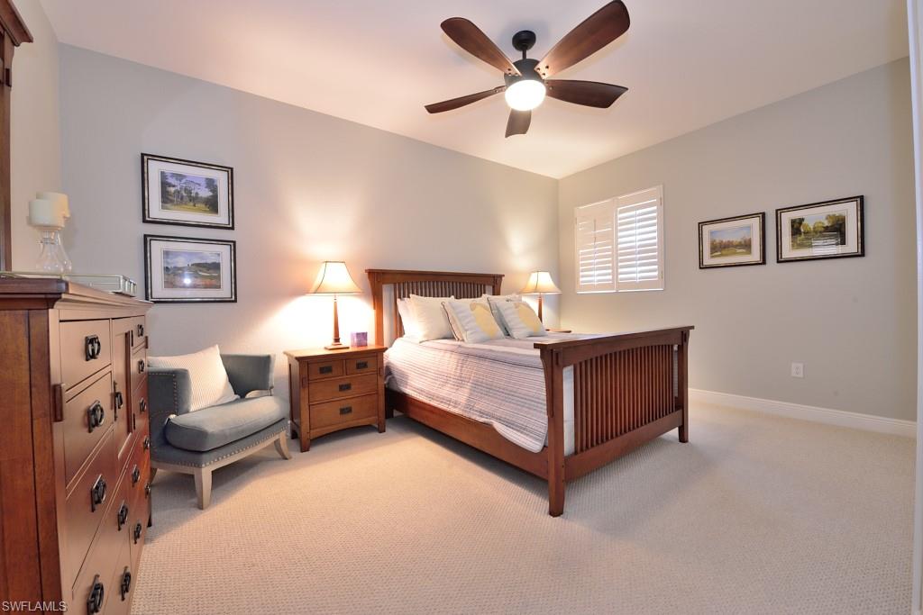 3960 Deer Crossing Court, Unit 6204 Naples, FL 34114 - Photo 21 of 23 a bedroom with a large bed and a couch