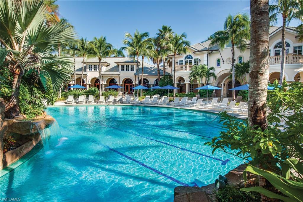 3960 Deer Crossing Court, Unit 6204 Naples, FL 34114 - Photo 22 of 23 a view of a swimming pool with a garden and plants