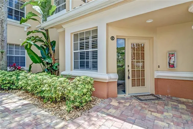 a house with potted plants in front of door