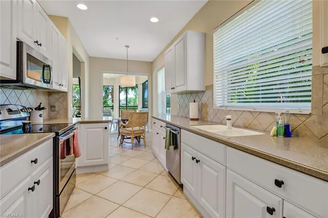 a kitchen with a sink stove and cabinets