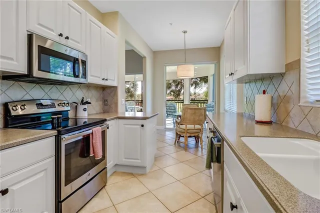 a kitchen with stainless steel appliances granite countertop a sink and a stove