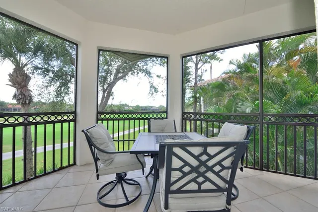 a view of a balcony with furniture and wooden floor