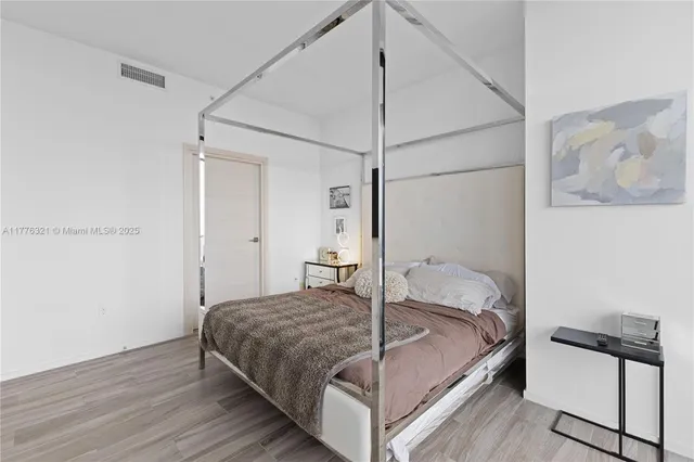 a bedroom with a bed and a mirror