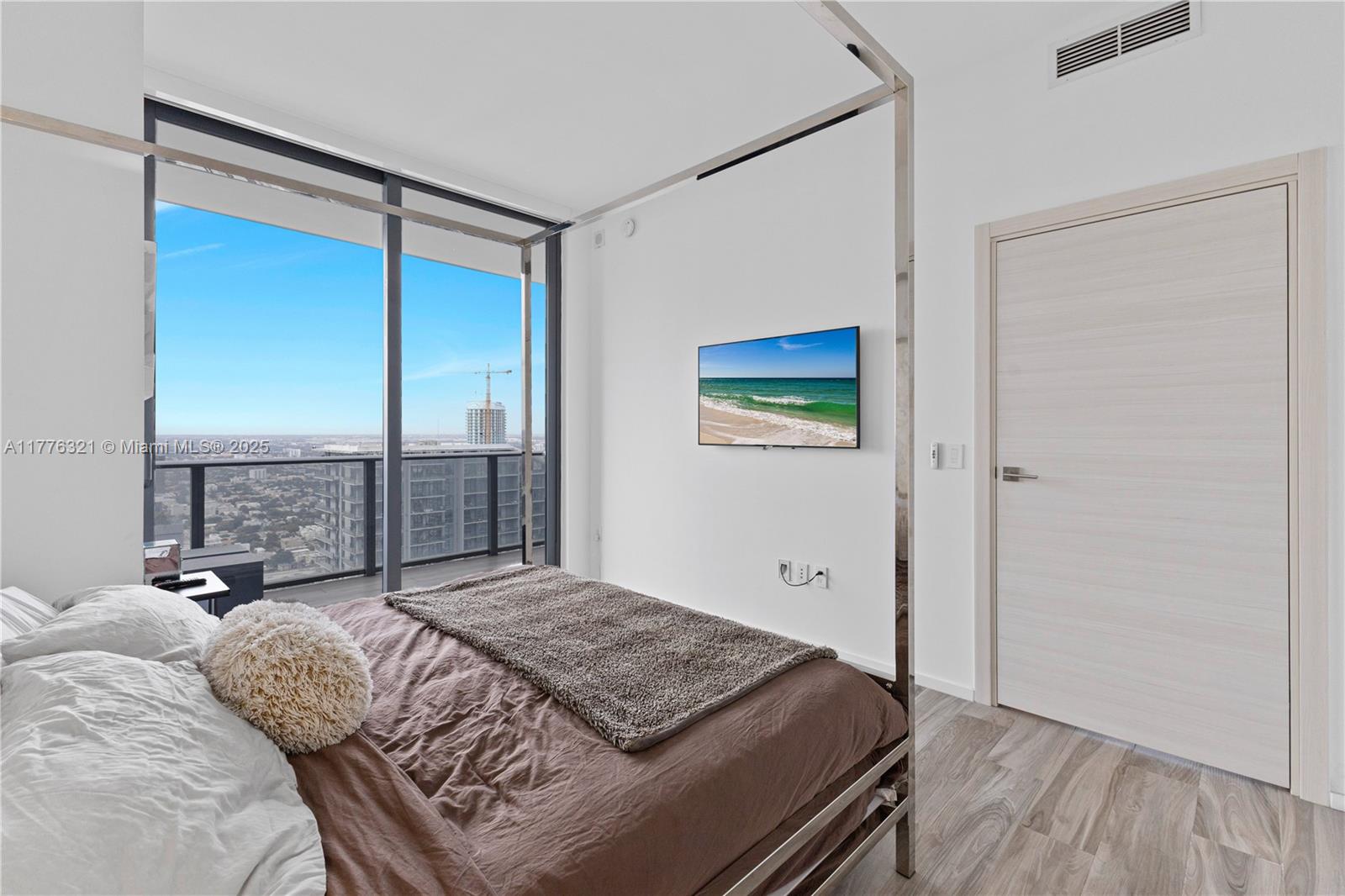801 South Miami Avenue, Unit 5209 Miami, FL 33131 - Photo 17 of 43 a bedroom with a large bed and a balcony view