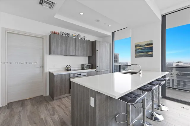 a kitchen with a table chairs and a refrigerator