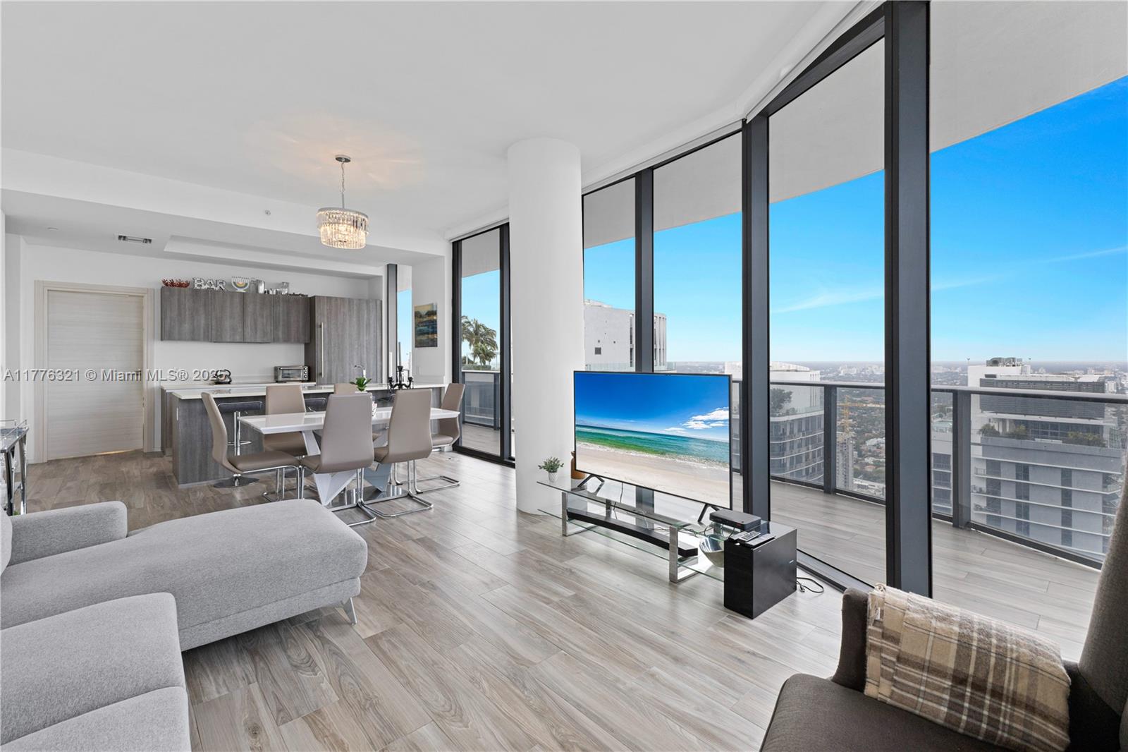 801 South Miami Avenue, Unit 5209 Miami, FL 33131 - Photo 9 of 43 a living room with couch floor to ceiling window and wooden floor