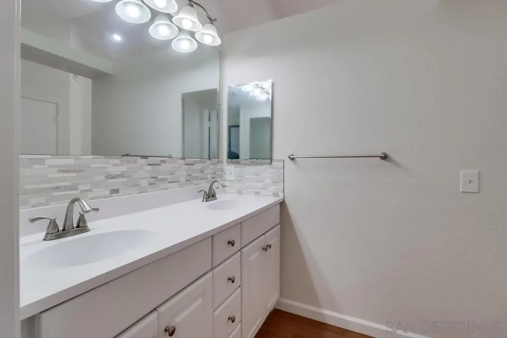 10310 Lake Ridge Court Spring Valley, CA 91977 - Photo 24 of 37 a bathroom with a sink a light fixture and a mirror