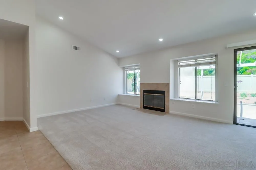 10310 Lake Ridge Court Spring Valley, CA 91977 - Photo 7 of 37 an empty room with windows and fireplace