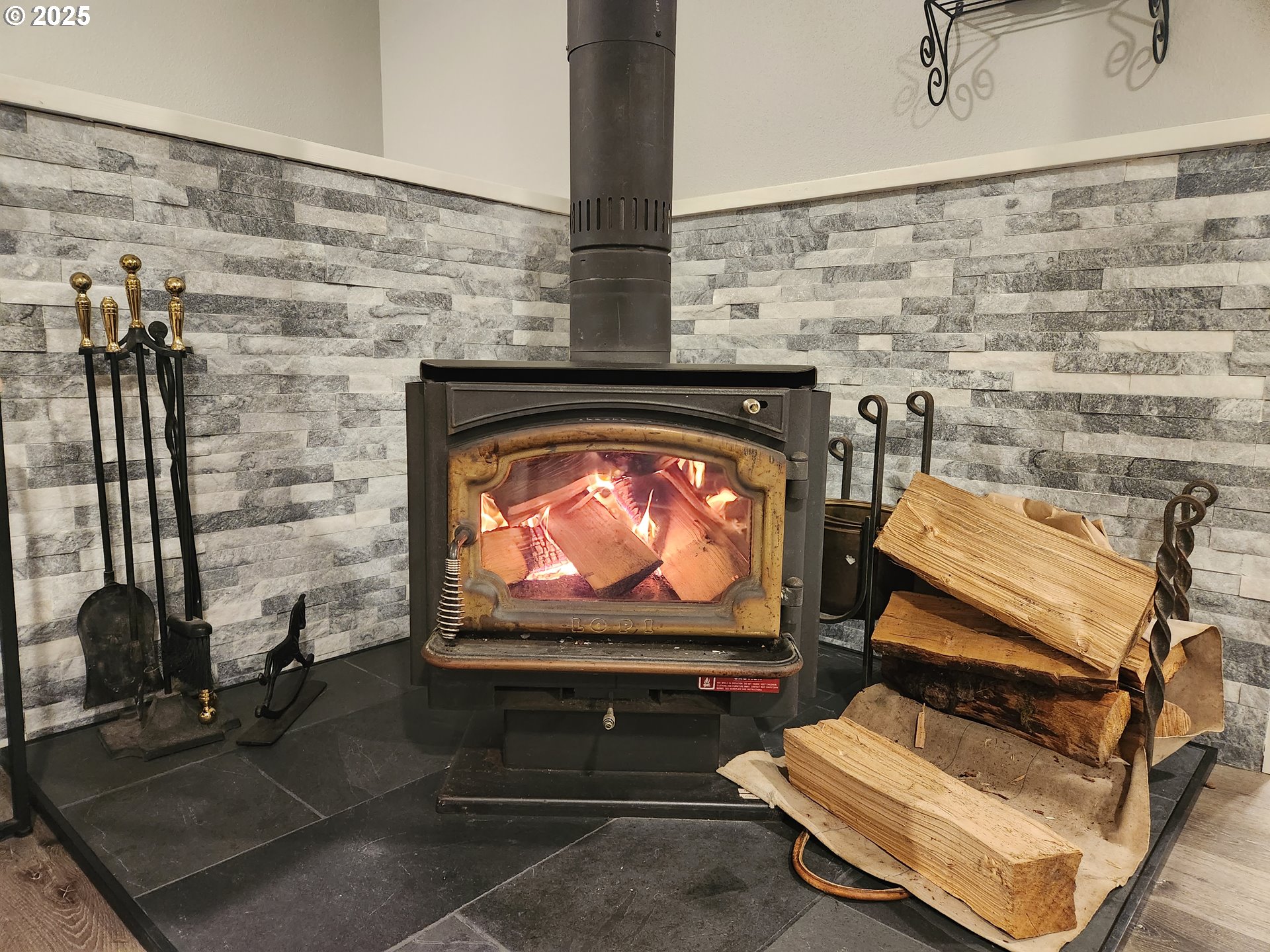 7495 Northeast Neptune Drive Lincoln City, OR 97367 - Photo 11 of 35 a living room with furniture and a fireplace
