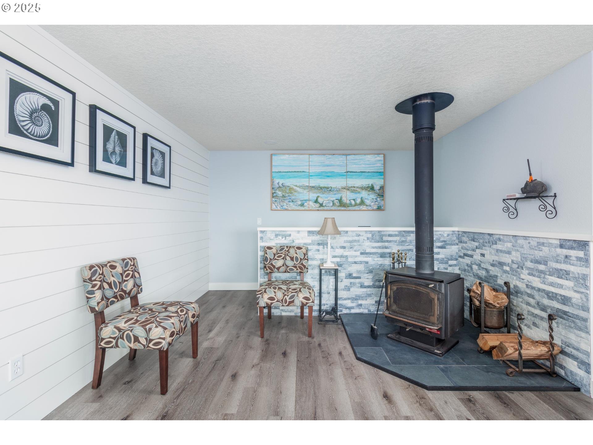 7495 Northeast Neptune Drive Lincoln City, OR 97367 - Photo 12 of 35 a living room with furniture and a fireplace