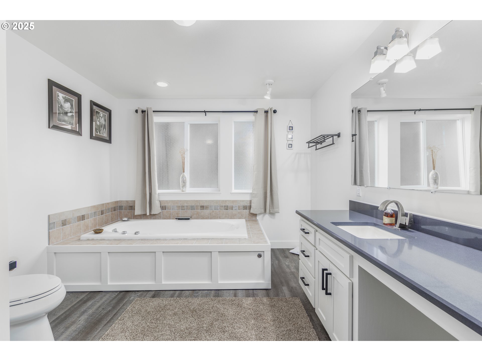 7495 Northeast Neptune Drive Lincoln City, OR 97367 - Photo 16 of 35 a bathroom with a sink double vanity granite tub and a toilet