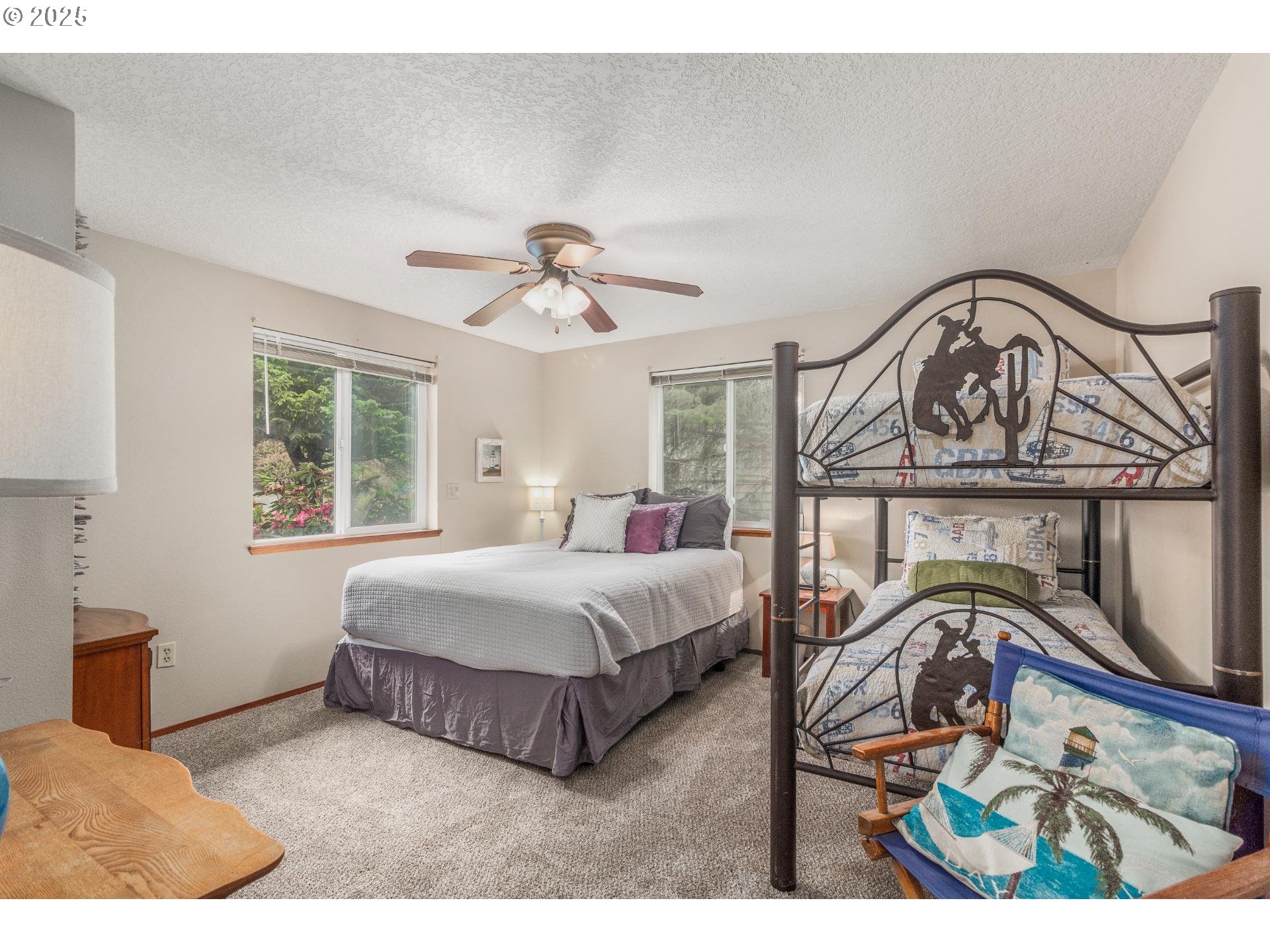 7495 Northeast Neptune Drive Lincoln City, OR 97367 - Photo 19 of 35 a living room with a bed furniture and a window
